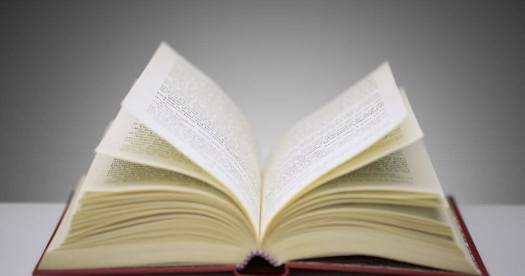 An open book on a table, inviting you to refine your draft, with a softly blurred background enhancing the focus.