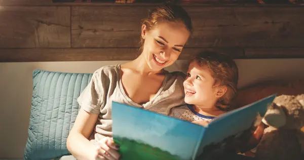 A woman and a child reading a book together, illustrating how I help my clients publish their books through shared knowledge.